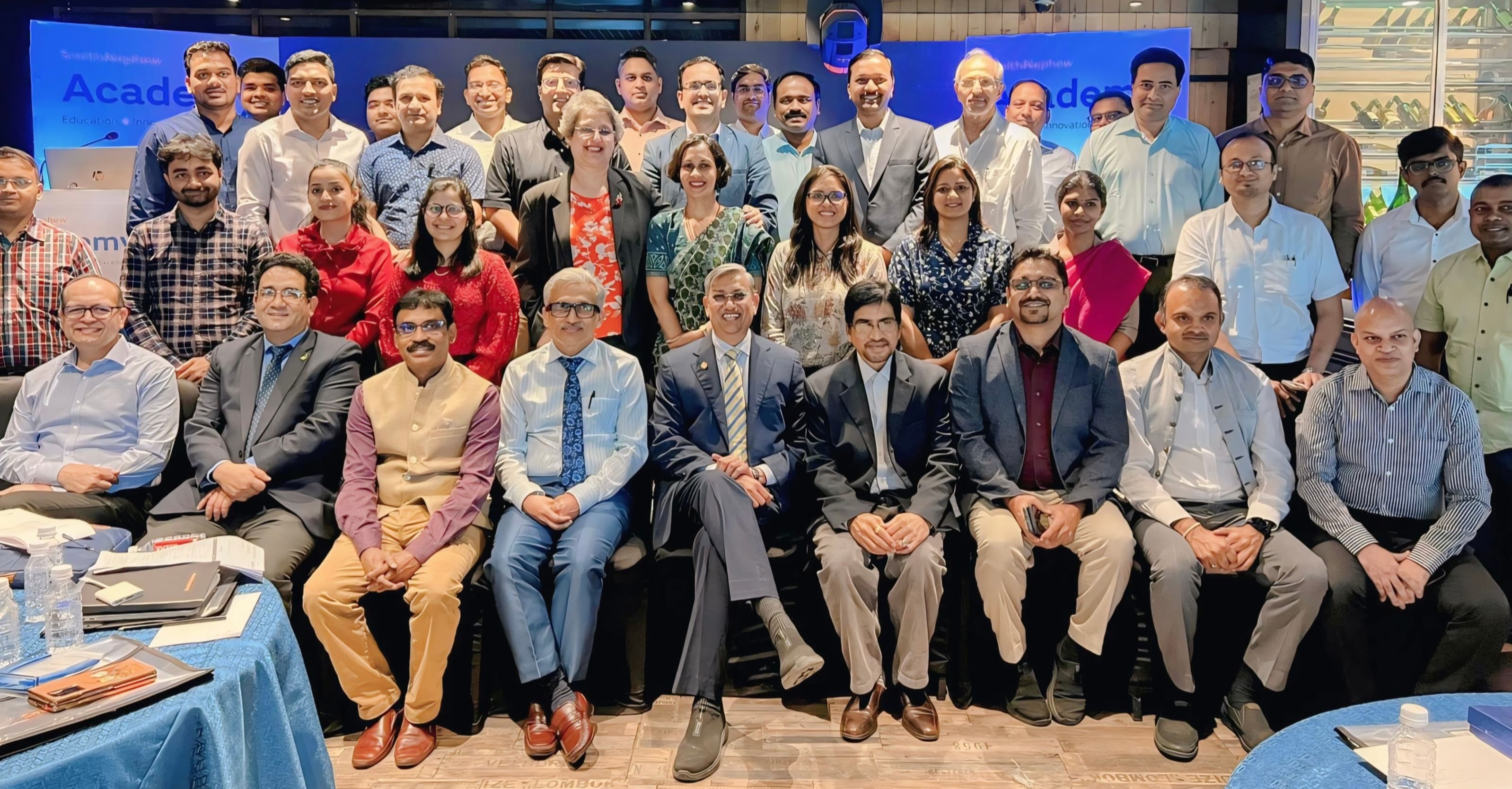 Vertical group portrait of Dr. S. Hussain with peers at a medical education CME conference